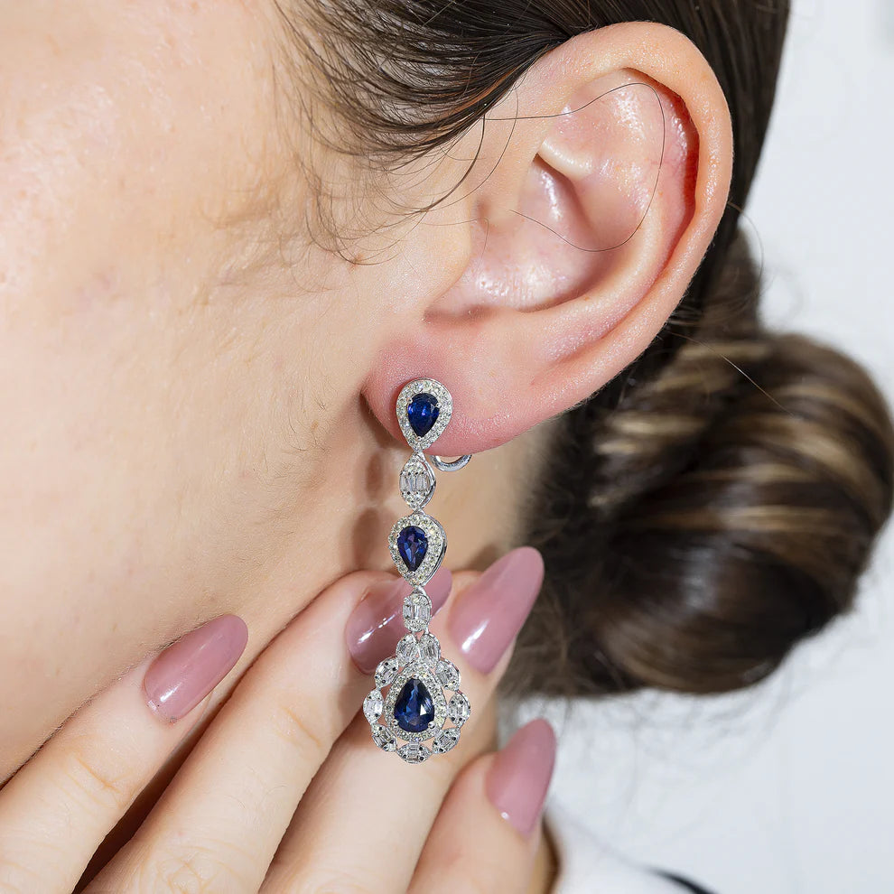 a woman wearing a 14K White Gold Pear Cut Sapphire & Diamond Drop Earrings